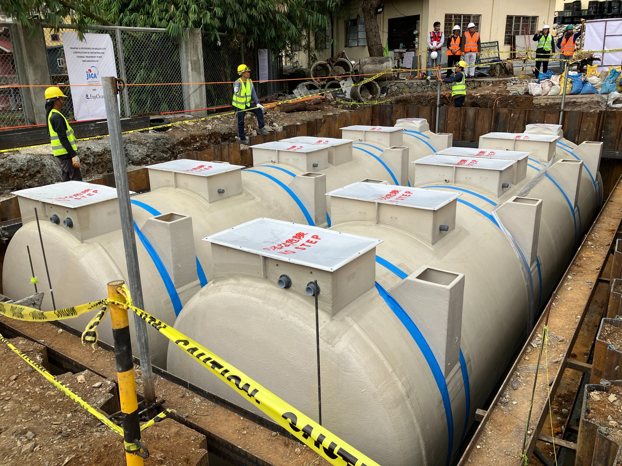 Lifting and placement of a FujiClean Johkasou system at a JICA-supported demonstration site in Baguio City, Philippines.